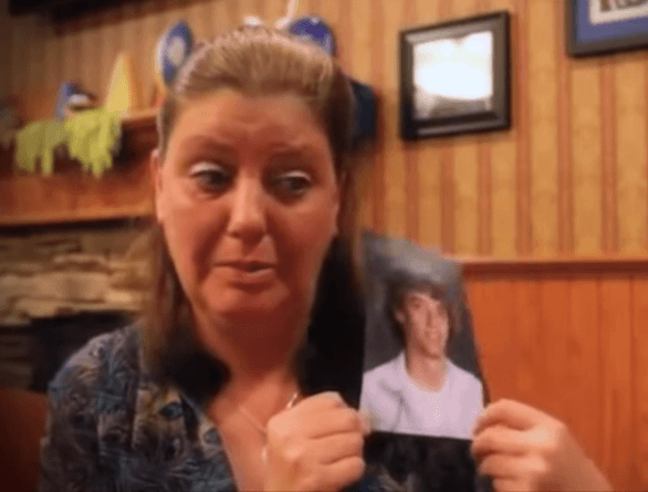 Brady Folkens mom crying with his picture