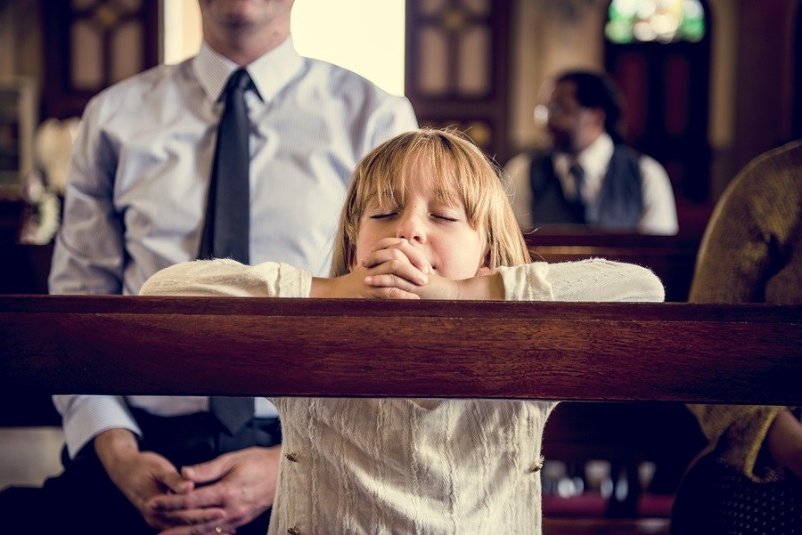 Little Girl Praying in Church photo