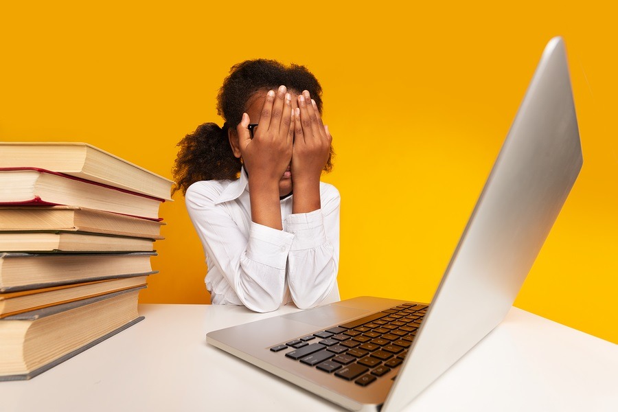 Overworking Black Schoolgirl Covering Face With Hands Sitting At